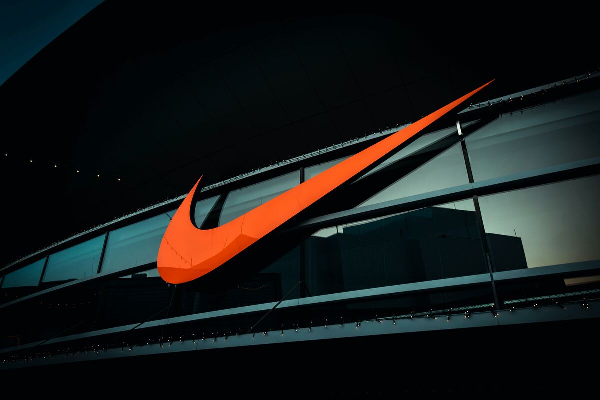 An orange Nike logo against the building. Dramatic cinematographic effect in the photo 